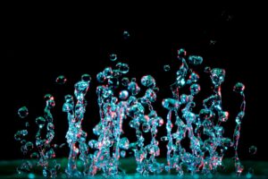 A striking close-up of vibrant water droplets capturing motion and abstract beauty.