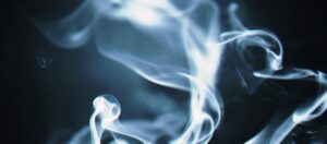 Artistic close-up of swirling white smoke against a dark background, creating a mystical effect.